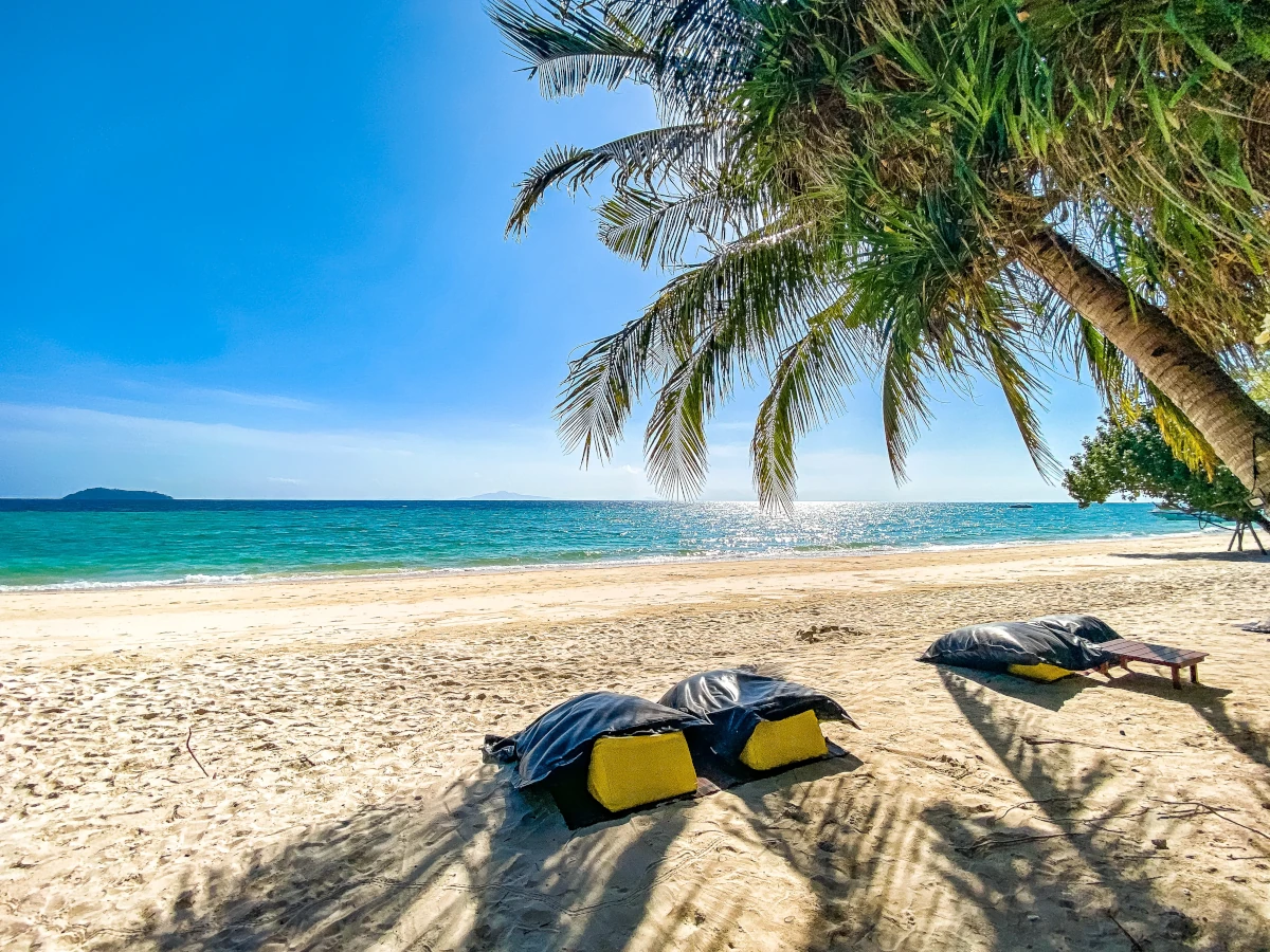 A very beautiful beach with sun and palm tree at >Koh Phi Phi, Thailand.